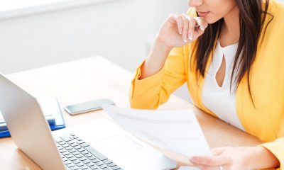 businesswoman working with documents and laptop pcj7f56 min e1524647237146