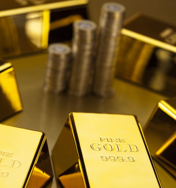 coins and gold bars finance concept e1559728125173