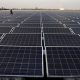 worker walks among solar panels at a floating solar plant developed by china s three gorges group in huainan e1559736599624