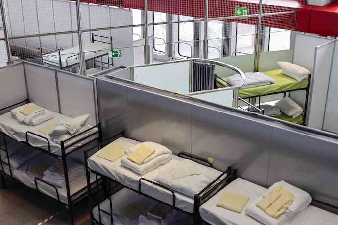 BERLIN, GERMANY - MARCH 25: Bed are prepared for refugees from Ukraine at an aid center set up at former Tegel airport on March 25, 2022 in Berlin, Germany. City authorities have installed a temporary shelter and registration center at Tegel as refugees from Ukraine continue to arrive daily in Berlin, many by rail via Poland. (Photo by Hannibal Hanschke/Getty Images)